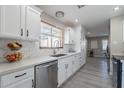 Modern kitchen with white cabinets, marble countertops, and stainless steel appliances at 8716 E Mitchell Dr, Scottsdale, AZ 85251