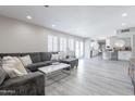 Spacious living room with gray sectional couch, light-colored flooring, and an open concept design at 8716 E Mitchell Dr, Scottsdale, AZ 85251