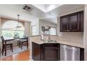 Open kitchen with stainless appliances, granite countertops, and adjacent dining area at 9451 E Becker Ln # 2016, Scottsdale, AZ 85260