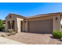 A well-maintained home showcasing a tiled roof, a spacious driveway, and mature landscaping, perfect for suburban living at 10311 E Trent Ave, Mesa, AZ 85212