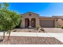 Charming home featuring a beautiful tiled roof, stucco exterior, and landscaped front yard, enhancing its curb appeal at 10311 E Trent Ave, Mesa, AZ 85212