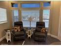 Cozy living room features two leather recliners and bright natural light at 111 S Greenfield Rd # 785, Mesa, AZ 85206