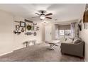 Inviting living room showcases neutral colors, lots of natural light, and comfortable seating at 13159 W Caribbean Ln, Surprise, AZ 85379
