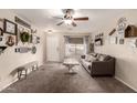 Cozy living room featuring neutral decor, a ceiling fan, and lots of natural light at 13159 W Caribbean Ln, Surprise, AZ 85379