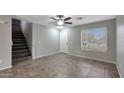 Inviting entryway with tile flooring, staircase, and ample natural light from the nearby window at 13261 W Gelding W Cir, Surprise, AZ 85379