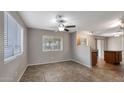 Bright living room with tile floors, ceiling fan, and easy access to the kitchen area at 13261 W Gelding W Cir, Surprise, AZ 85379