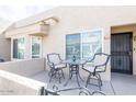 Quaint front patio with bistro set, ideal for relaxing outdoors at 14300 W Bell Rd # 222, Surprise, AZ 85374