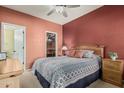 Charming bedroom with a patterned bedspread, wooden headboard, and a closet with shelving at 145 N 74Th St # 240, Mesa, AZ 85207