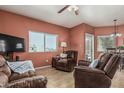 Comfortable living room with brown leather furniture, light wood floors, and a bright window view at 145 N 74Th St # 240, Mesa, AZ 85207
