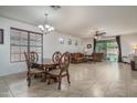 Spacious living room featuring a dining area, tile flooring, and natural light at 15140 W Glenrosa Ave, Goodyear, AZ 85395