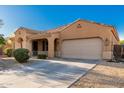 Charming single-story home featuring a well-manicured front yard, a two-car garage, and a covered front porch at 16600 W Washington St, Goodyear, AZ 85338