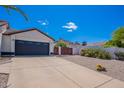 Spacious driveway leading to a two-car garage with mountain views in the background at 1811 E Tierra Buena Ln, Phoenix, AZ 85022