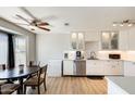 Modern kitchen with white cabinets, stainless steel appliances, and an adjacent dining area with lots of light at 1915 S 39Th St # 37, Mesa, AZ 85206