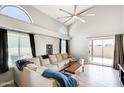 Bright living room with high ceilings, fan, lots of natural light, a large sectional, and sliding glass doors at 1915 S 39Th St # 37, Mesa, AZ 85206