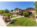 Beautiful home exterior with well-manicured lawn, mature trees, and charming architectural details at 1946 E Caroline Ln, Tempe, AZ 85284
