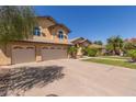 Stunning home exterior featuring lush landscaping, a spacious driveway, and a convenient three-car garage at 1946 E Caroline Ln, Tempe, AZ 85284