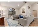 Inviting living room featuring plush sofas, a cozy rug, and a large window offering natural light at 1946 E Caroline Ln, Tempe, AZ 85284