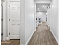 Hallway view features modern flooring and neutral tones, leading to open living spaces at 20251 W Hadley St, Buckeye, AZ 85326