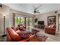 Bright living room with hardwood floors, a ceiling fan, and sliding glass doors to the outdoor patio at 20660 N 40Th St # 1118, Phoenix, AZ 85050