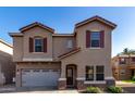 Inviting two-story home featuring a well-manicured front yard, a red tile roof, and a two-car garage at 2116 S Shelby --, Mesa, AZ 85209