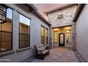 Inviting courtyard with a cozy cushioned bench and elegant brick paving at 2166 N Steele --, Mesa, AZ 85207
