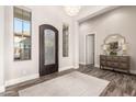 Elegant entryway featuring a decorative front door, wood floors, and stylish furnishings at 2166 N Steele --, Mesa, AZ 85207