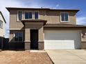 Charming two-story home featuring a neutral stucco exterior, a spacious two-car garage, and a classic architectural design at 22382 W Monona Ln, Surprise, AZ 85387
