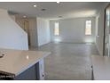Bright, open-concept living room features neutral walls, tile flooring, and plenty of natural light at 22382 W Monona Ln, Surprise, AZ 85387