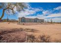 Single-story home featuring desert landscaping, seen from driveway with desert vegetation in background at 2248 S Nikki Ln, Maricopa, AZ 85139
