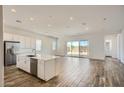 Spacious living area offers a large kitchen island and sliding doors to the backyard, ideal for indoor-outdoor living at 25338 N 150Th Ln, Surprise, AZ 85387