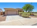Single-story home with a two-car garage, desert landscaping, and a well-kept front lawn at 25617 W St James Ave, Buckeye, AZ 85326