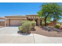 Charming single-story home with a well-manicured yard, desert landscaping, and a two-car garage at 25617 W St James Ave, Buckeye, AZ 85326