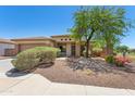 Single-story home with a desert-style landscaped front yard and a neatly maintained lawn area at 25617 W St James Ave, Buckeye, AZ 85326