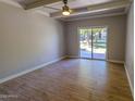 Bright bedroom featuring wood-look tile floors and a sliding glass door to the backyard at 357 E Thomas Rd # A112, Phoenix, AZ 85012
