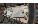 Overhead view of a private backyard with a pool, covered patio, and desert landscaping at 4001 N 300Th Ln, Buckeye, AZ 85396
