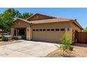 Charming single-story home featuring a well-maintained front yard and a two-car garage at 4216 N Dania Ct, Litchfield Park, AZ 85340