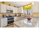 Bright kitchen with stainless steel appliances, granite countertops, and ample cabinet space at 4420 E Amberwood Dr, Phoenix, AZ 85048