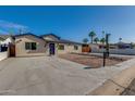 Charming single-story home with a low-maintenance desert landscape and a concrete driveway at 542 E Flynn Ln, Phoenix, AZ 85012