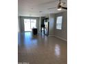 Living room with dark island and stainless appliances with a view of the backyard at 7218 E Grouse Ct, San Tan Valley, AZ 85143