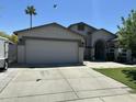 Charming single-story home featuring a spacious driveway, two-car garage, desert landscaping and a well-maintained lawn at 9001 W Windsor Ave, Phoenix, AZ 85037