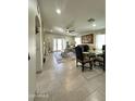 Inviting living room with tile flooring, ample natural light, and a dining area, perfect for gatherings and relaxation at 9001 W Windsor Ave, Phoenix, AZ 85037