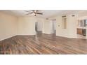 Spacious living room with updated wood-look flooring and a ceiling fan for added comfort and style at 9151 W Greenway Rd # 212, Peoria, AZ 85381