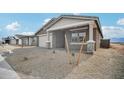 View of single-story home with desert landscaping and an attached two-car garage at 9533 W Luxton Ln, Tolleson, AZ 85353