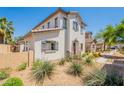 View of the home exterior with a textured white facade, tile roof, and desert landscaping at 10324 W Sands Dr # 476, Peoria, AZ 85383