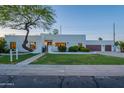 Charming home with a unique tree in the front yard, beautiful landscaping and an inviting entryway at 10532 N 79Th St, Scottsdale, AZ 85258