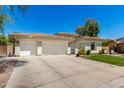 Attractive home featuring a tile roof, three-car garage, and a well-manicured front yard at 1096 E Lodgepole Dr, Gilbert, AZ 85298