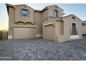 This exterior elevation features a 3-car garage and paver driveway at 10984 N 164Th Dr, Surprise, AZ 85388