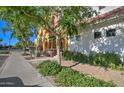 Townhouse exterior featuring colorful facade, complemented by manicured landscaping and inviting walkway at 123 N Washington St # 16, Chandler, AZ 85225