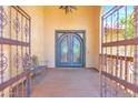 Grand arched double-door entryway with iron detailing and wooden porch at 1338 W Mountain View Dr, Mesa, AZ 85201