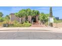 Charming home exterior with a covered entryway and desert landscaping at 1338 W Mountain View Dr, Mesa, AZ 85201